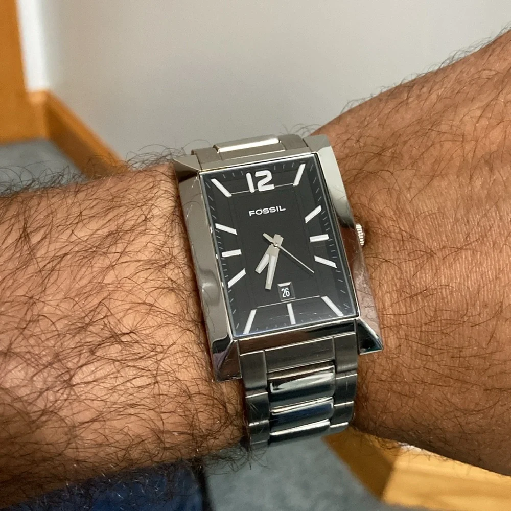 Fossil tank style rectangular case watch, black dial.  Stainless steel.